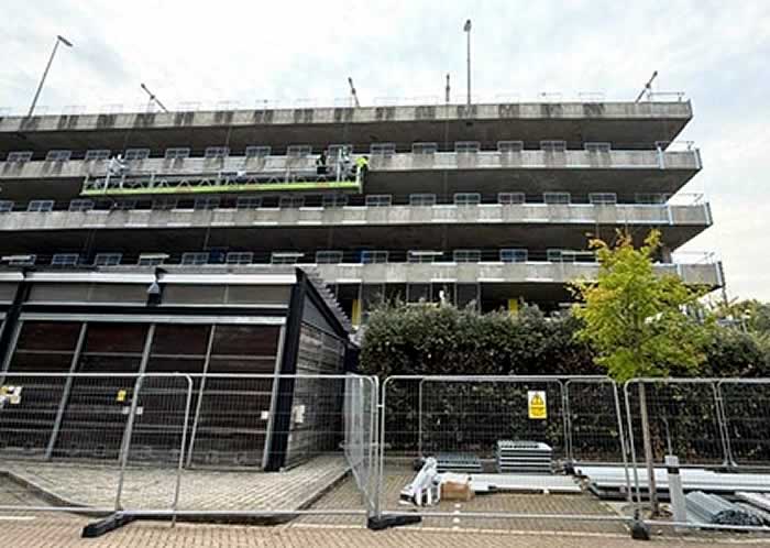 Access cradles set up to facilitate cladding repairs